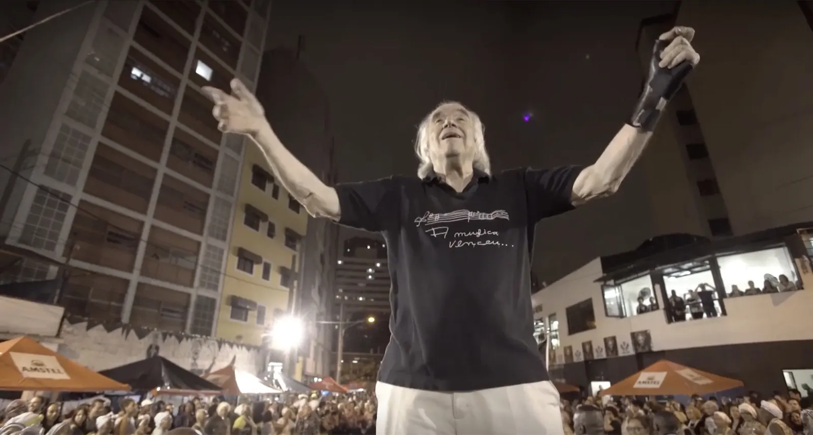 João Carlos Martins de braços abertos diante do público